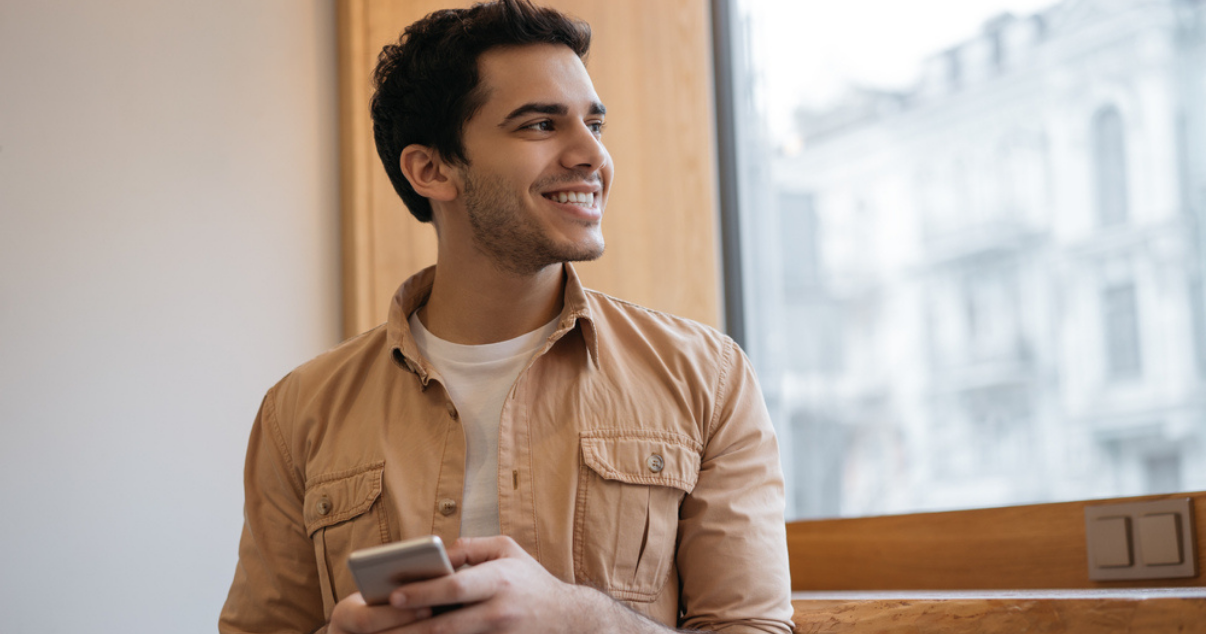 Man using his phone while learning more about billforward platform