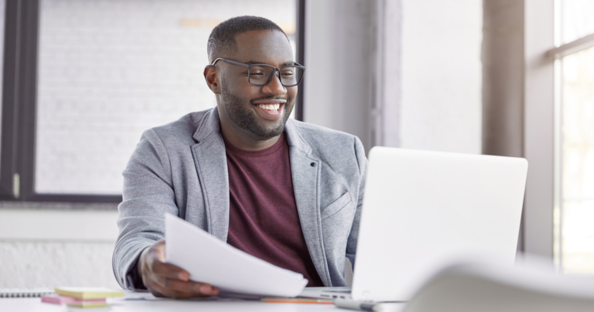 Happy businessman learning more about his payment stack